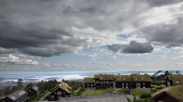 Aerial view of traditional Norwegian grass roof homes with a view towards the city of Oslo and the Oslo fjord. 