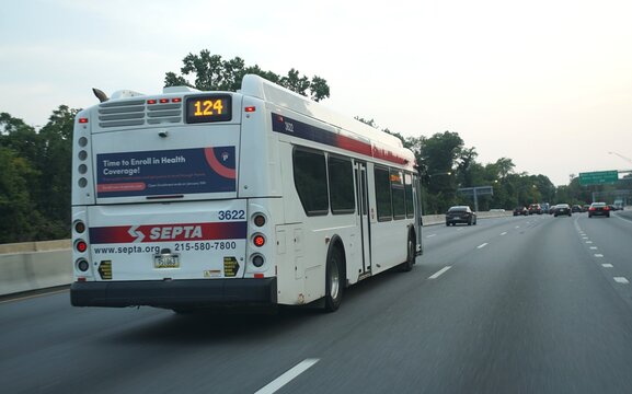 SEPTA bus on highway displaying health coverage enrollment advertisement and route number 124.