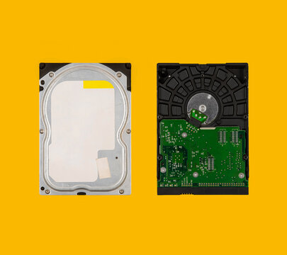 Two computer hard drives top and bottom view isolated on yellow back