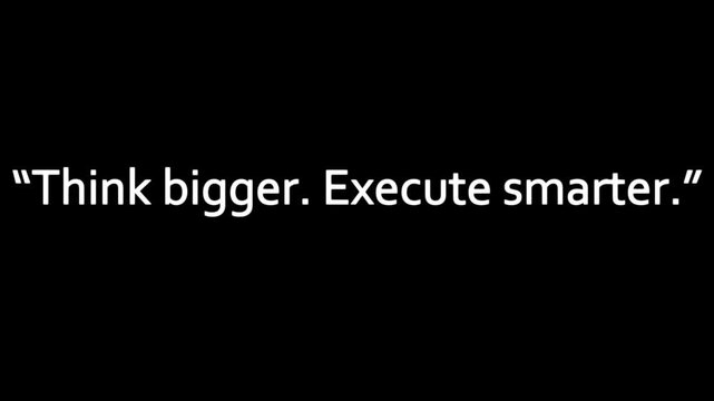 Lettering displaying an inspiring business slogan in clean white serif font centered on a minimal dark canvas for corporate presentations.