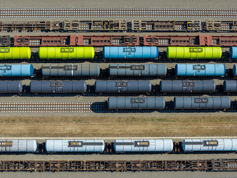 Aerial view of Emplacement Kijfhoek featuring colorful tank cars and freight trains lined up on parallel tracks in the industrial railway yard in Zwijndrecht, Zuid-Holland, Netherlands.