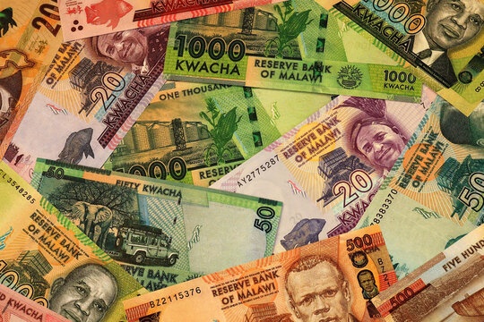 Malawian kwacha money bills in pile on table. Malawi MWK currency cash close up