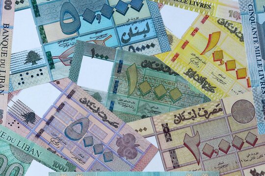 Lebanese pound money bills in pile on table. Lebanon LBP currency cash close up