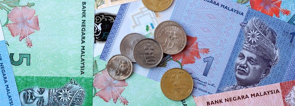 Malaysian ringgit money banknotes and coins on table. Malaysia cash bills of MYR currency