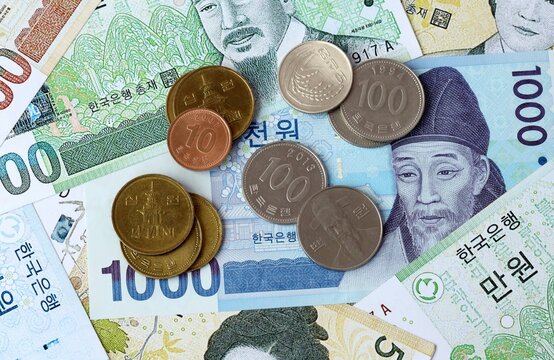 South Korean won money banknotes and coins on table. South Korea cash bills of KRW currency