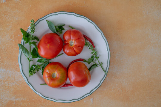 Homegrown tomatoes with herbs on a rustic tabletop