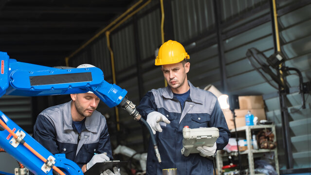 Industrial Automation Specialist inspecting robotic components Near a Blue Robotic Arm in a Production Environment Scene 14