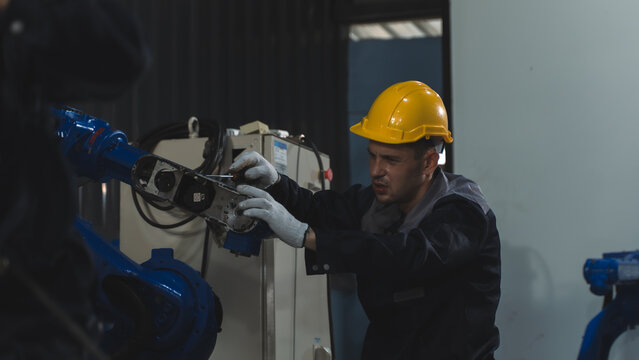Maintenance maintenance specialist working together on machine diagnostics on Robotic Production Equipment Inside a Modern Factory