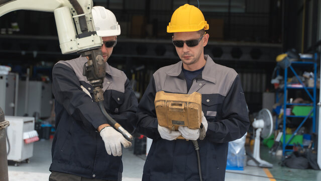 Factory Technician assessing industrial machinery During Routine Inspection of Automated Robotic Equipment Scene 206