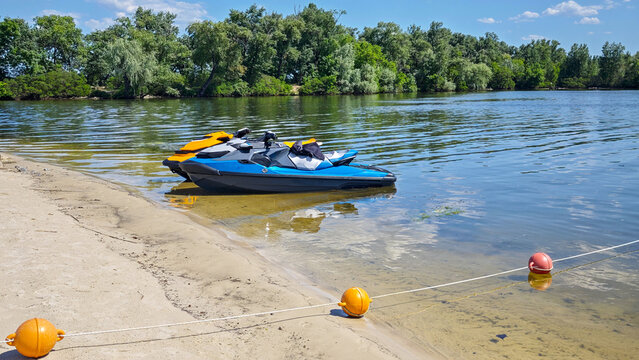 Personal Watercraft Parked on Sandy Lake Shore on Sunny Summer Day