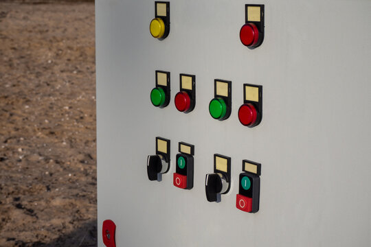 Close up of outdoor electrical control panel box with colorful push buttons and switches. Real Photo