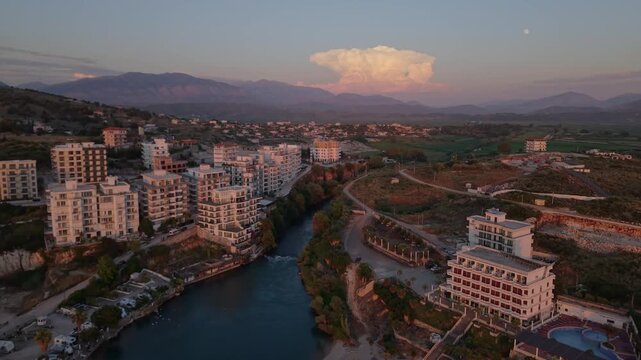 Aerial view of modern apartment buildings lining the river in Sarande, Vlore County, Albania.