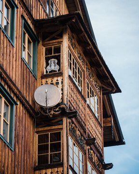 View of a traditional wooden house with intricate carvings and a balcony in Hallstatt, Upper Austria, Austria.