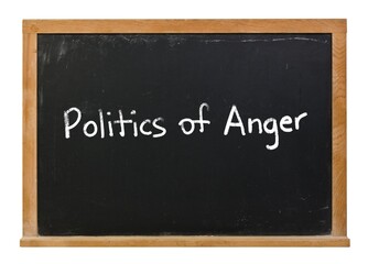 Fototapeta premium Politics of Anger written in white chalk on a black chalkboard isolated in a wooden frame on white
