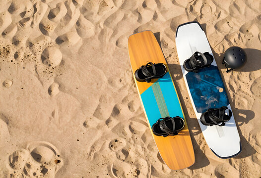 Summer beach sports and outdoor adventure, two kiteboards and helmet on sandy beach with copy space