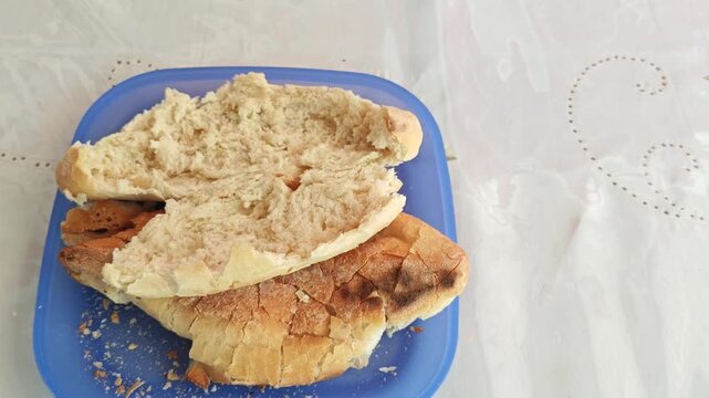 Pressing Toasted Crusty Bread Roll on a Plate