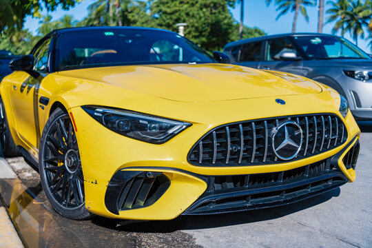 Miami, Florida, USA - December 07, 2025: 2022 Mercedes AMG SL 63 luxury convertible car. Luxury convertible Mercedes Benz AMG. Car Mercedes Benz AMG parked outdoor. Yellow car, front view