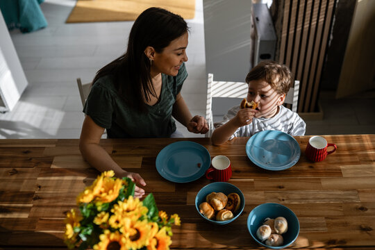 Mother and son enjoying breakfast together at home