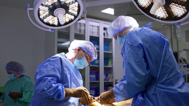 Professional male surgeons perform operation on foot. Trauma operation progress in modern hospital.
