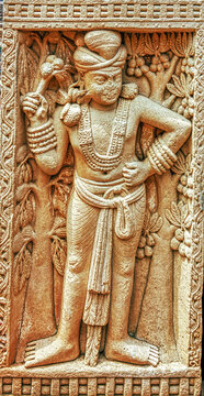 Ancient Yaksha Figure Carved on Stone Gateway Relief at Sanchi Stupa Complex, India