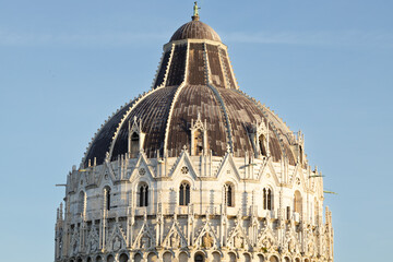 Architectural dome of a historic building featuring intricate stonework and decorative elements against a clear blue sky in a European city © Vlad Yakubovskiy