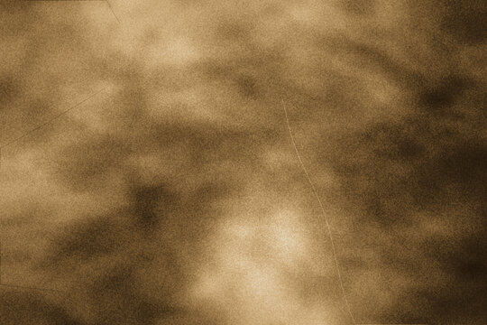 Abstract sepia brown background with a grainy texture, ideal for antique photographs and classic vintage projects.