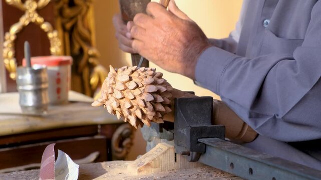 Woodcarver shaping the textured fur of a wooden wolf sculpture with a mallet and chisel in a traditional restoration workshop. Wood Carving Artisan Shapes Wolf Sculpture Fur With Mallet And Chisel