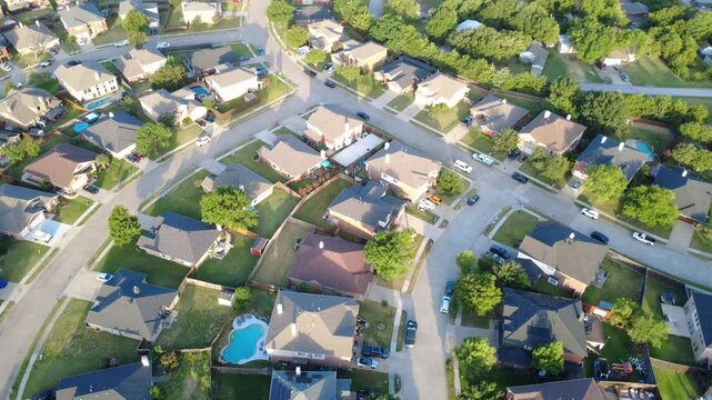 Sweeping cul de sac avenues connect family properties across Lakewood Estates. Solar panel installations, kidney splash pools, mature yard trees portray orderly master planning, Little Elm, Texas