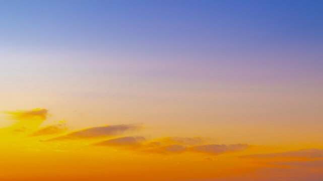 Horizon natural sunset sky, Panorama view with wonderful blue and golden yellow skyline, Amazing purple and orange sky in evening during the sun going down, Nature abstract background.