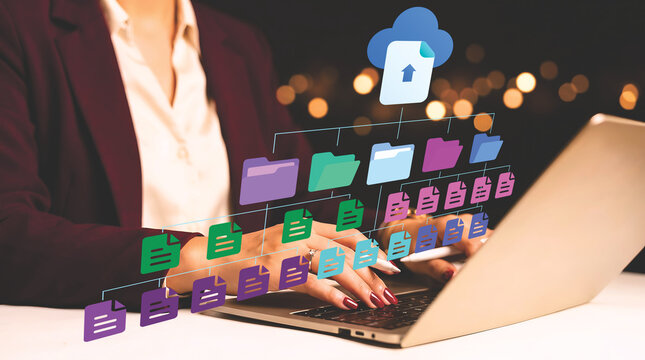 Businesswoman organizing and synchronizing digital files and folders with cloud storage on her laptop