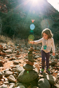 Girl Building a Rock Cairn