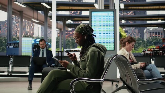 Woman takes a picture of a boarding pass in a bus terminal while searching the route itinerary online, reviewing bus ticket information on her mobile phone before departure as a female passenger.
