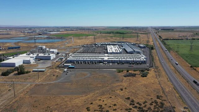 4K aerial drone footage of a hyperscale data center campus of a leading ecommerce and cloud services company near I-84 freeway and the Columbia River in Boardman, Oregon, USA with power substation