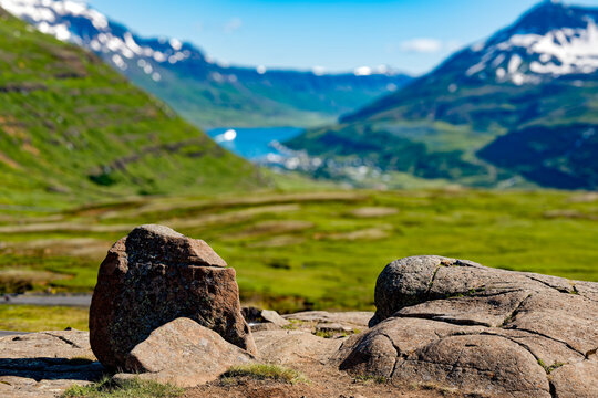 Glacier Boulders with Sey&eth;isfj&ouml;r&eth;ur Town and Fjord in Background