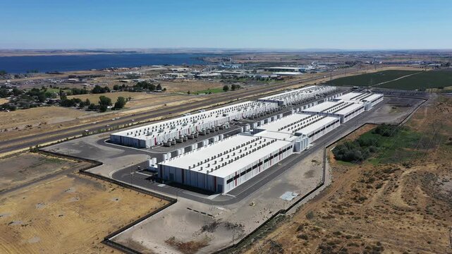 4K aerial drone footage of a hyperscale data center campus of a leading ecommerce and cloud services company near I-84 freeway and the Columbia River in Boardman, Oregon, USA with power substation