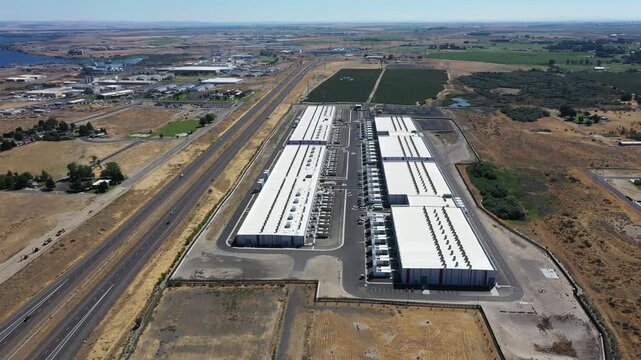 4K aerial drone footage of a hyperscale data center campus of a leading ecommerce and cloud services company near I-84 freeway and the Columbia River in Boardman, Oregon, USA with power substation