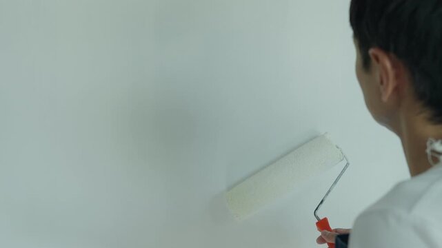 painter man, brush in hand for products to restore and paint the wall, indoor the building site of a house, wall during painting, renovation, painting, contractor, Architect, construction worker