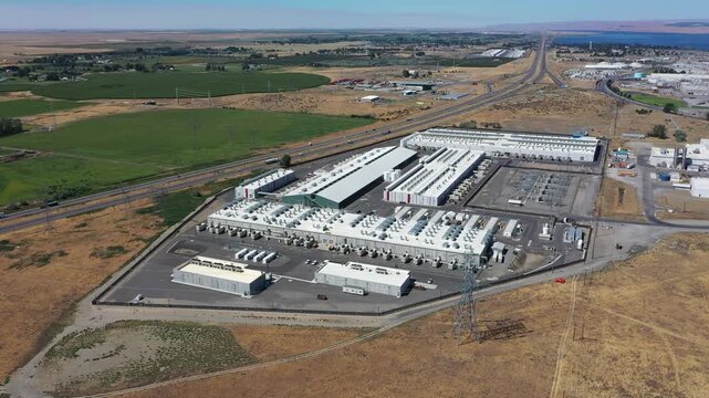 4K aerial drone footage of a hyperscale data center campus of a leading ecommerce and cloud services company near I-84 freeway and the Columbia River in Boardman, Oregon, USA with power substation