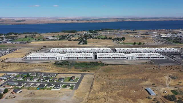 4K aerial drone footage of a hyperscale data center campus of a leading ecommerce and cloud services company near I-84 freeway and the Columbia River in Boardman, Oregon, USA with power substation