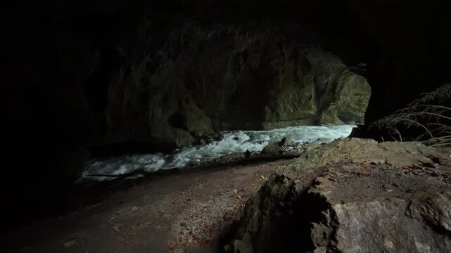 Powerful underground river carving its way through the dark Weaver Cave, also known as Tkalca jama, in the Rakov Skocjan valley, Slovenia