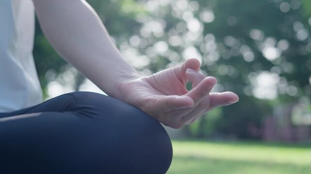 woman practicing meditate on the park. Asian woman doing exercises in morning. balance, recreation, relaxation, calm, good health, happy, relax, healthy lifestyle, reduce stress, peaceful, Attitude.