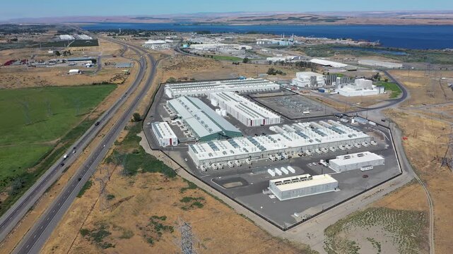 4K aerial drone footage of a hyperscale data center campus of a leading ecommerce and cloud services company near I-84 freeway and the Columbia River in Boardman, Oregon, USA with power substation