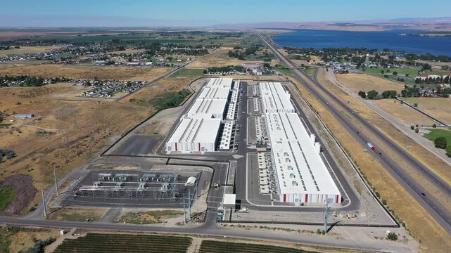 4K aerial drone footage of a hyperscale data center campus of a leading ecommerce and cloud services company near I-84 freeway and the Columbia River in Boardman, Oregon, USA with power substation