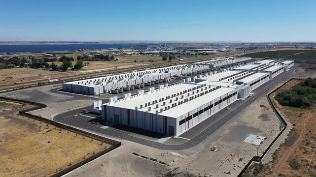 4K aerial drone footage of a hyperscale data center campus of a leading ecommerce and cloud services company near I-84 freeway and the Columbia River in Boardman, Oregon, USA with power substation