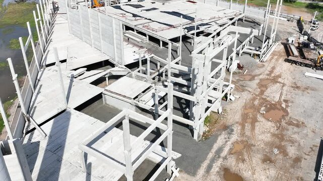 Modern Prefabricated Concrete Building Under Construction with Precast Columns Wall Panels and Hollow Core Floor Slabs, Aerial View