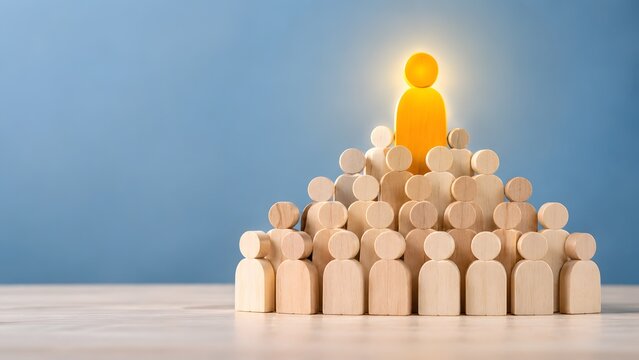 Glowing yellow wooden figure standing at the peak of a crowd pyramid. Concept of exceptional business leadership and finding the right talent.
