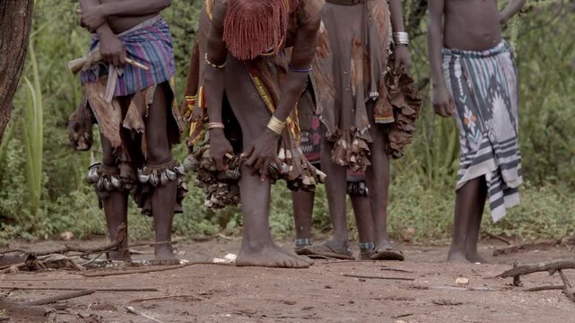 Women of the Hamar Tribe of the Omo Valley of Ethiopia put on bells for a wedding ceremony.