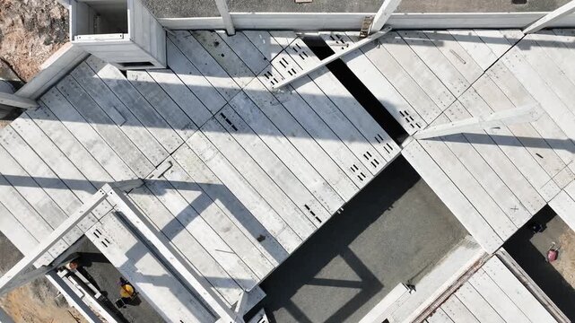 Modern Prefabricated Concrete Building Under Construction with Precast Columns Wall Panels and Hollow Core Floor Slabs, Aerial View