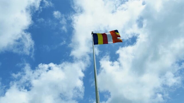 Waving Buddhist Flag Under Blue Sky in Sri Lanka