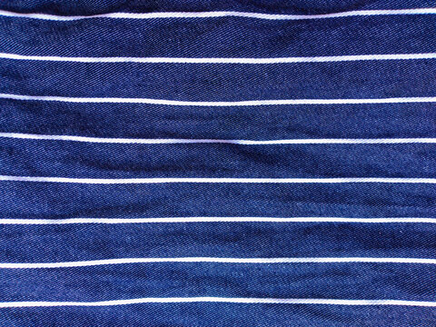 Blue jeans denim fabric background with white pinstripe pattern